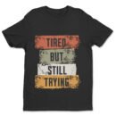 Premium Unisex Crewneck T-Shirt – 'Tired But Still Trying' Graphic Tee